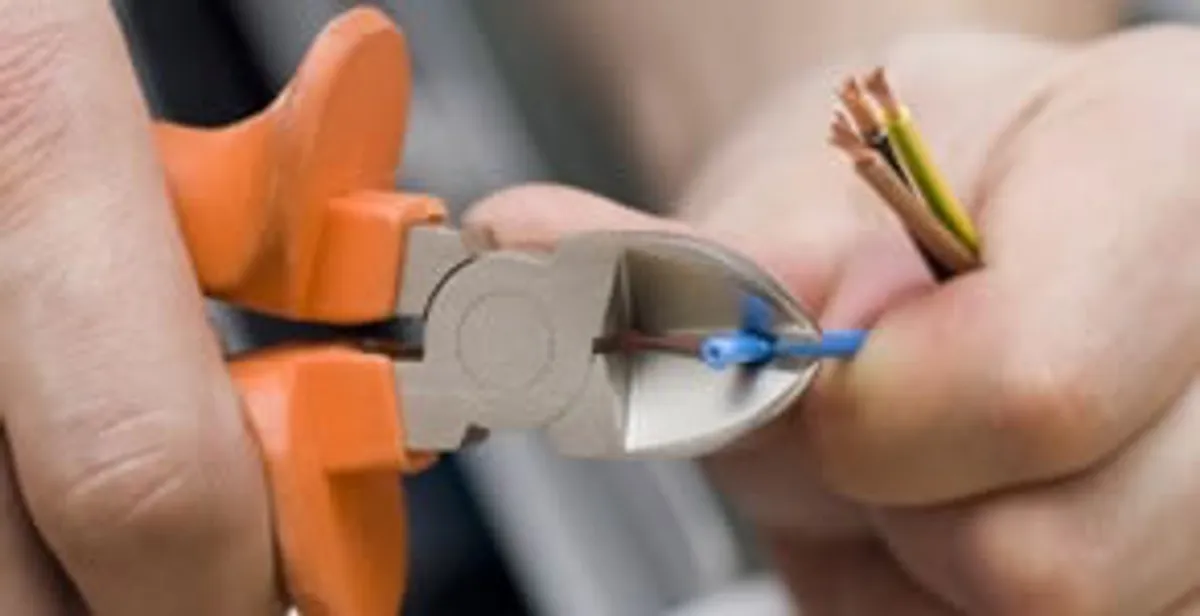 professional electrical services showing precise wire cutting by licensed electricians in Escondido, CA